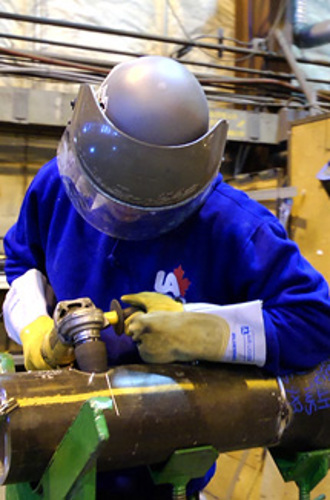 Steamfitter/pipefitter working in a shop