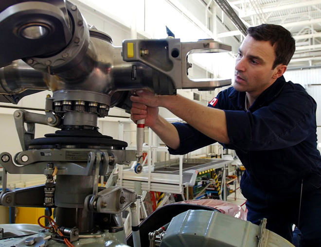 Aircraft maintenance technician working on an airplane engine
