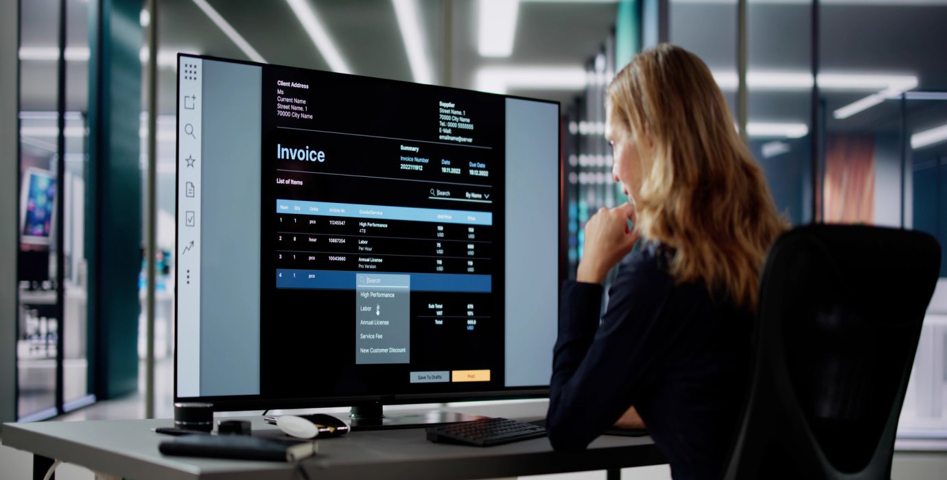 Person using computer software to manage invoices.