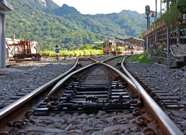 Train tracks with mountains in the background
