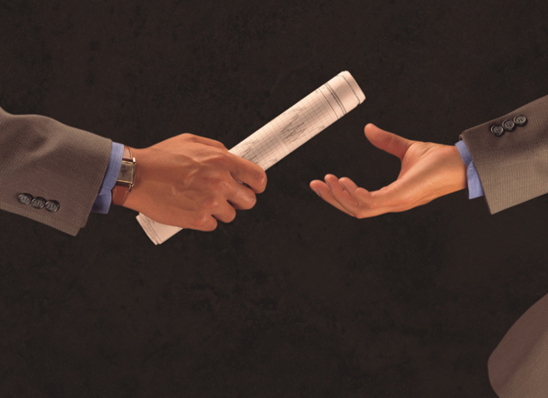 Business workers on a team passing documents