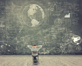Person looking at a giant chalkboard filled with drawings and text