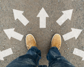 Feet amid arrows pointing in different directions