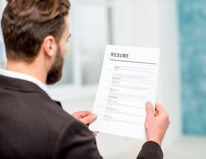 Person looking at a resumé 