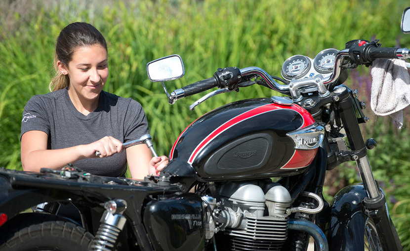 Motorcycle mechanic tuning a motorcycle