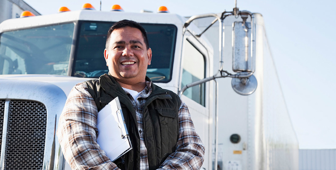 Transport officer standing in front of a semi-trailer truck