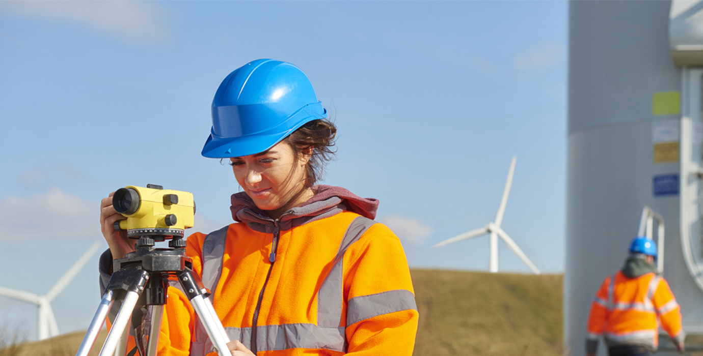 Person using technical instruments outside