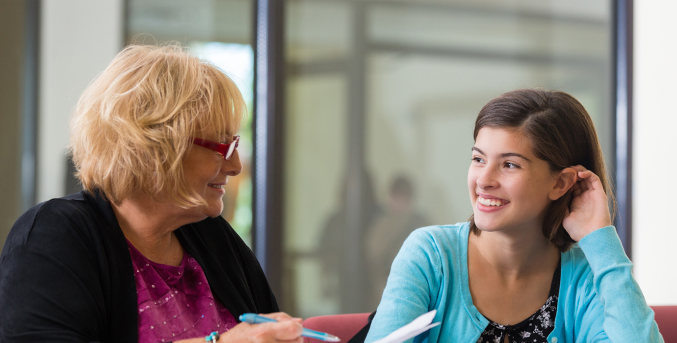 Youth talking to an adult in an office