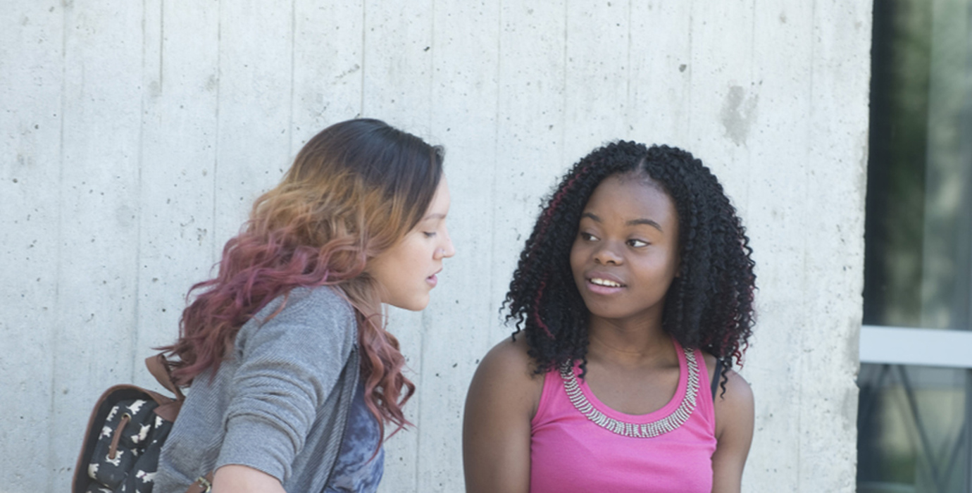 Youth having a discussion about a booklet outside