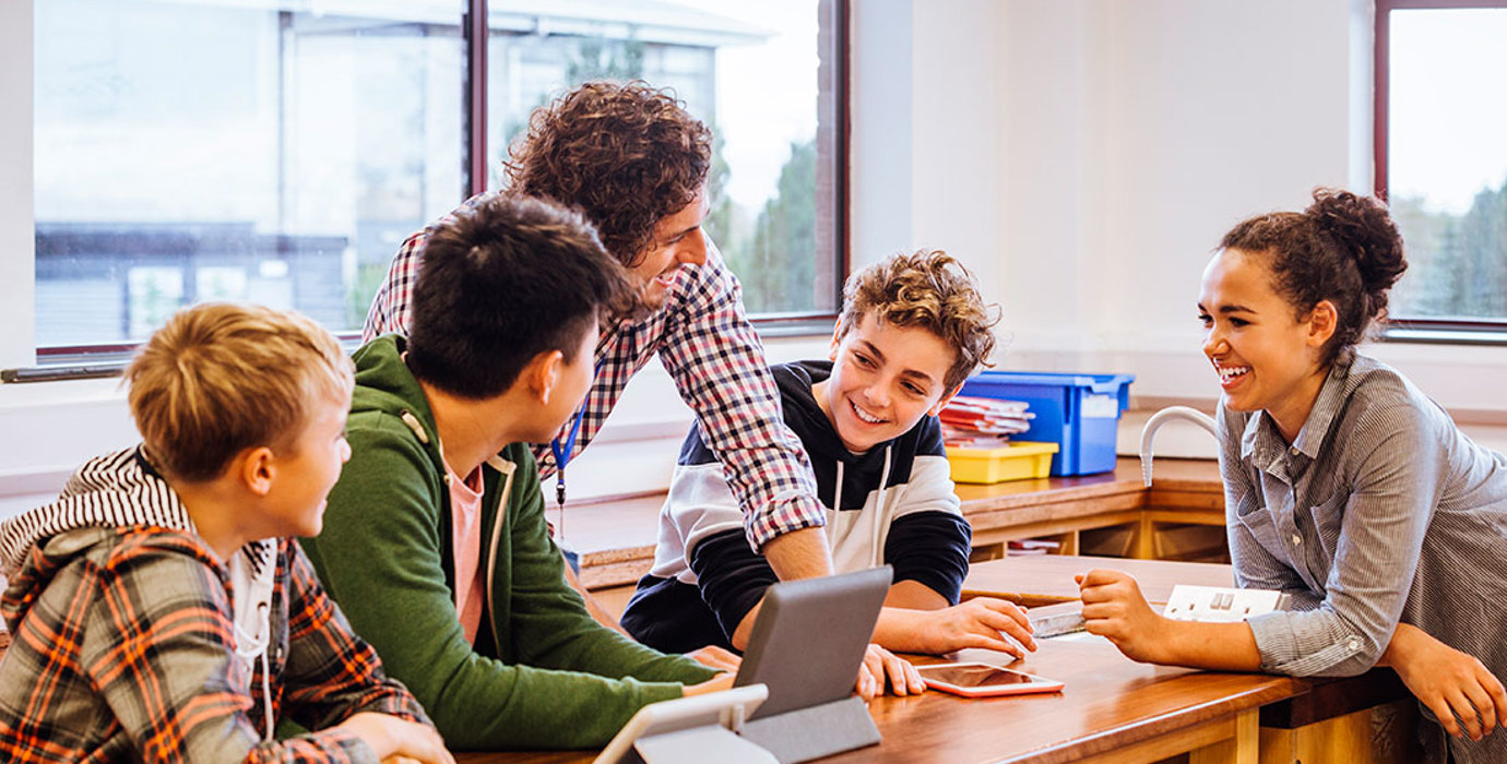 Teacher having a discussion with students in a classroom