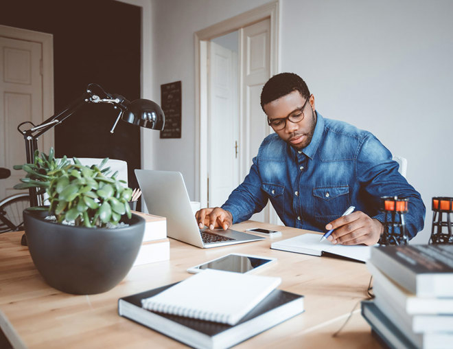 Person working from home office with a laptop