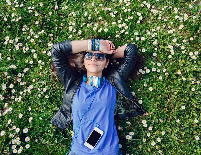 Youth smiling and lying on the grass 