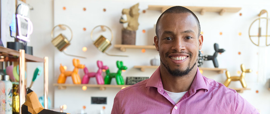 Entrepreneur holding a box of origami in a store
