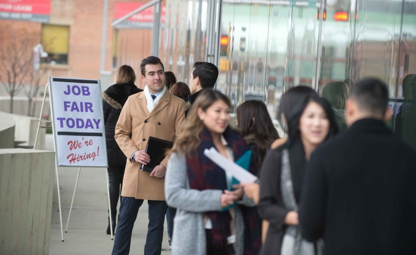 Job seekers standing in line at a job fair