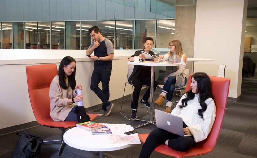 Students hanging out in a small common area on campus