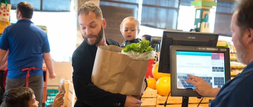 Parent with children at the grocery checkout