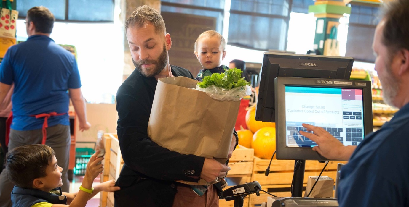 Parent with children at the grocery checkout