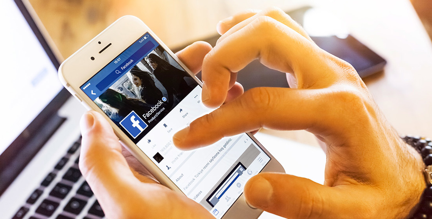 Closeup of hands holding a mobile phone and scrolling