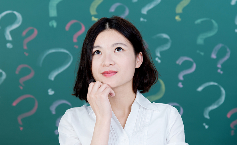 Person looking up with chin in hand in front of a background of question marks