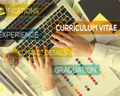 Hands on a laptop keyboard with superimposed text: curriculum vitae, qualifications, experience, contact details, graduation