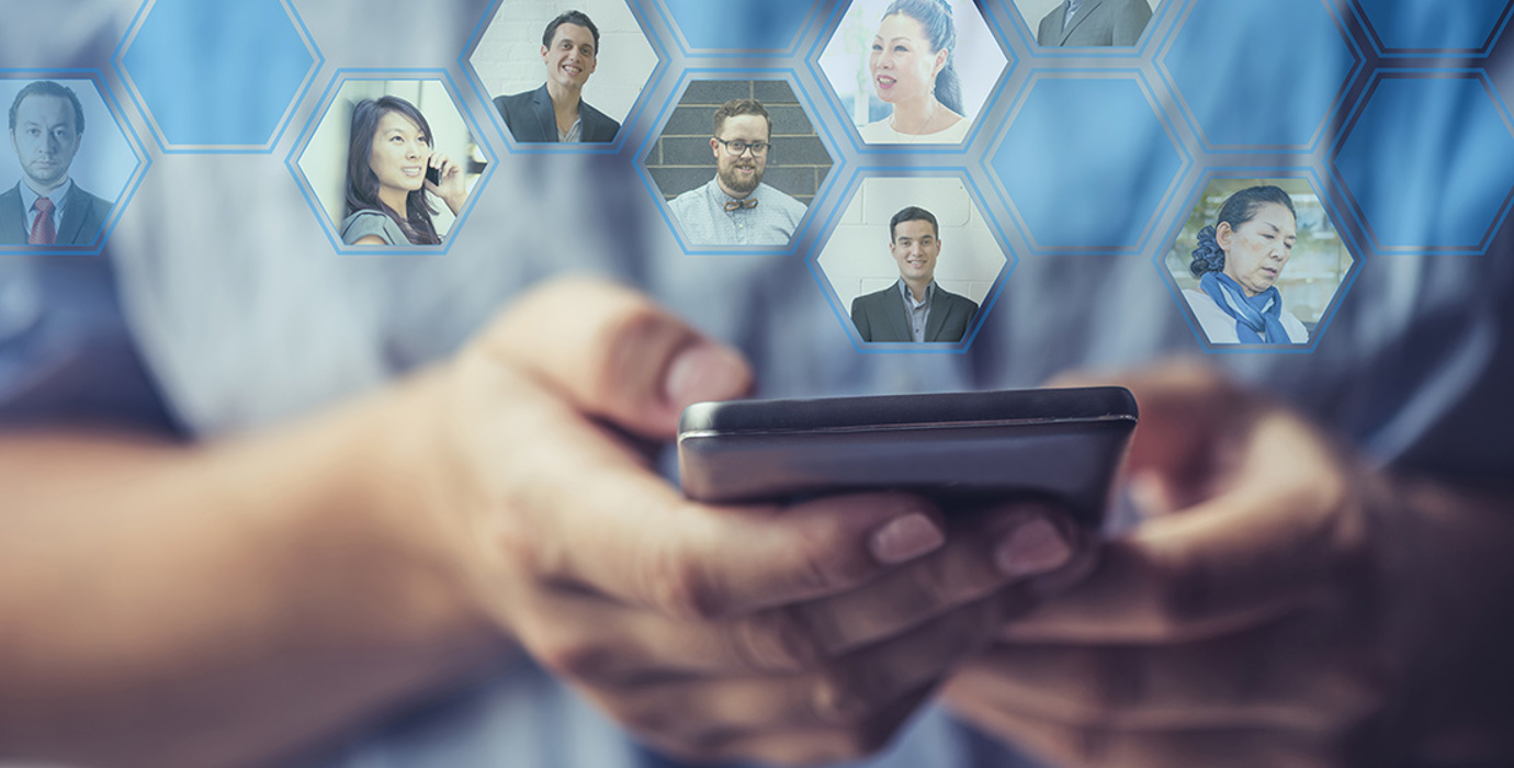 Hands holding a smartphone with profile photos of their network coming out of the phone