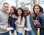 Post-secondary students standing in London with Tower Bridge in the background