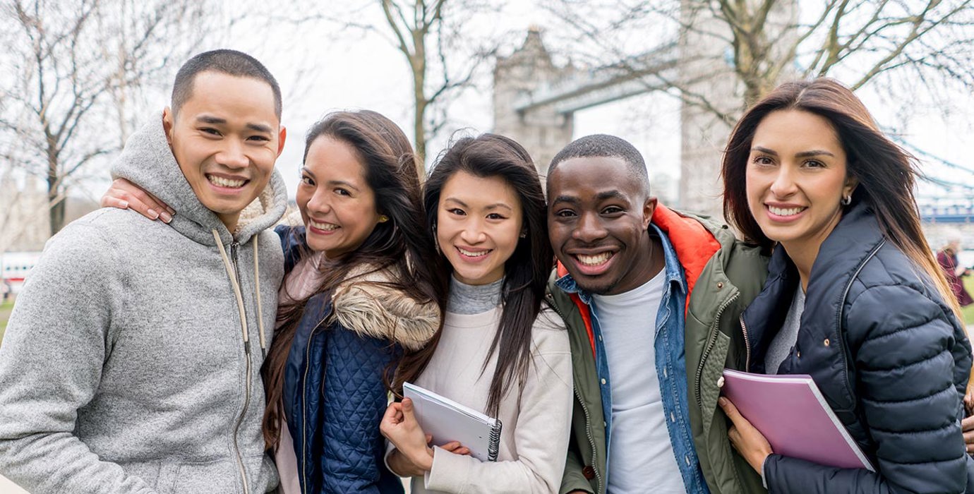 Post-secondary students standing in London with Tower Bridge in the background