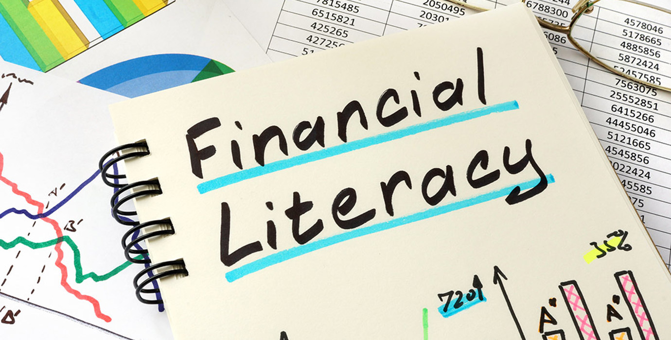 Notebook with colourful graphs with handwritten title "Financial Literacy"