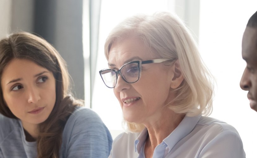 Mature worker in a meeting with coworkers