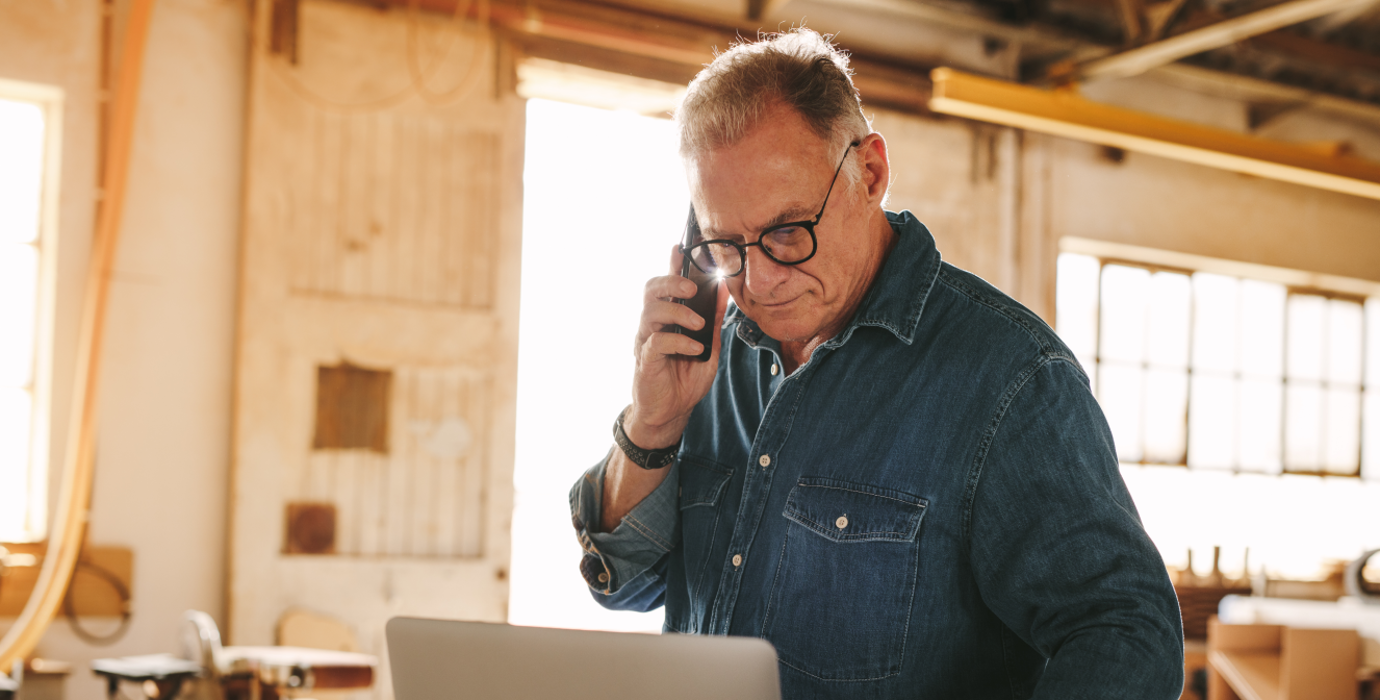 Carpenter on the phone in a workshop