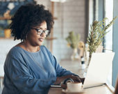 Woman working on her laptop in a coffee shop.