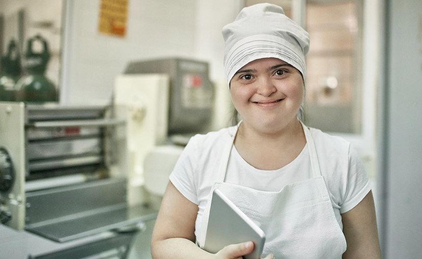 A happy worker in a pasta factory.