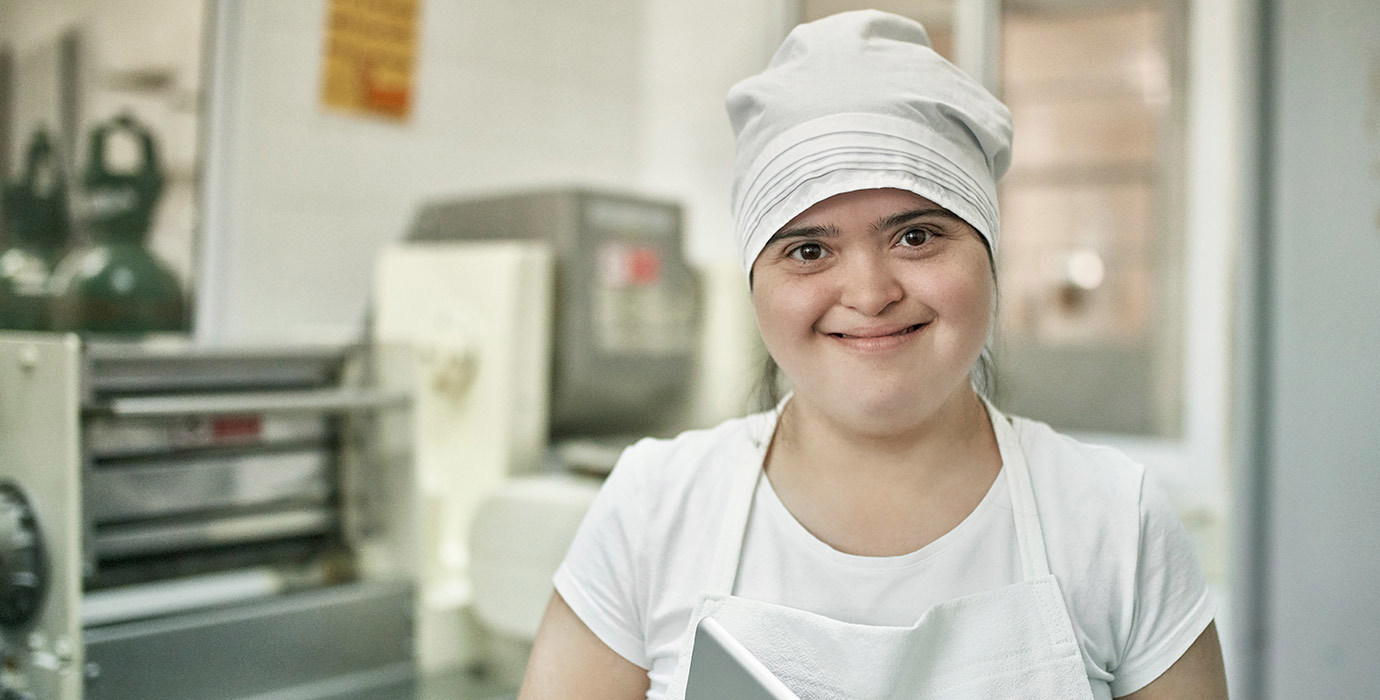 A happy worker in a pasta factory.
