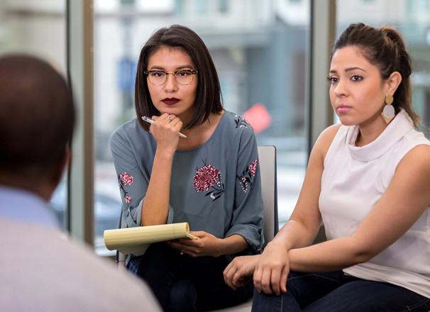 3 people have a serious discussion in the workplace.