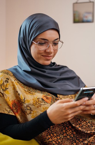 Person using smartphone while sitting on couch.