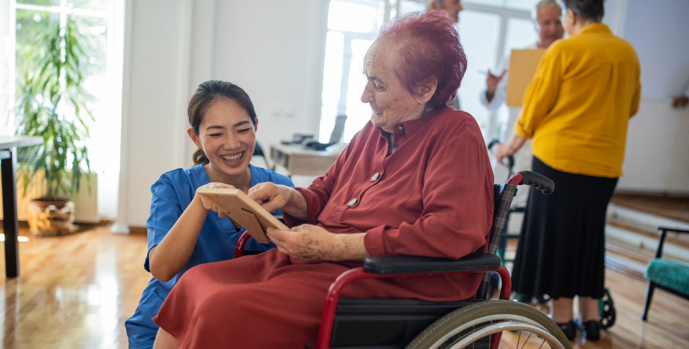 Homecare worker helping person in wheelchair.