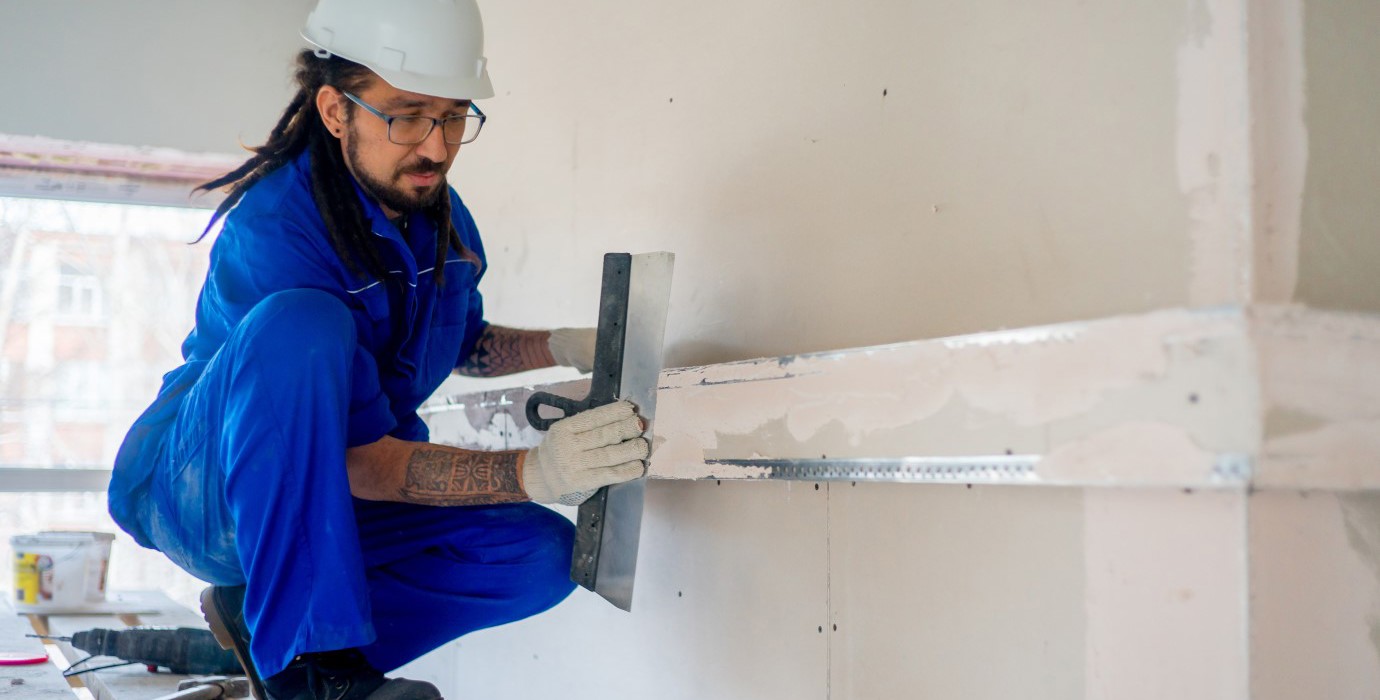 Construction worker finishing a wall.