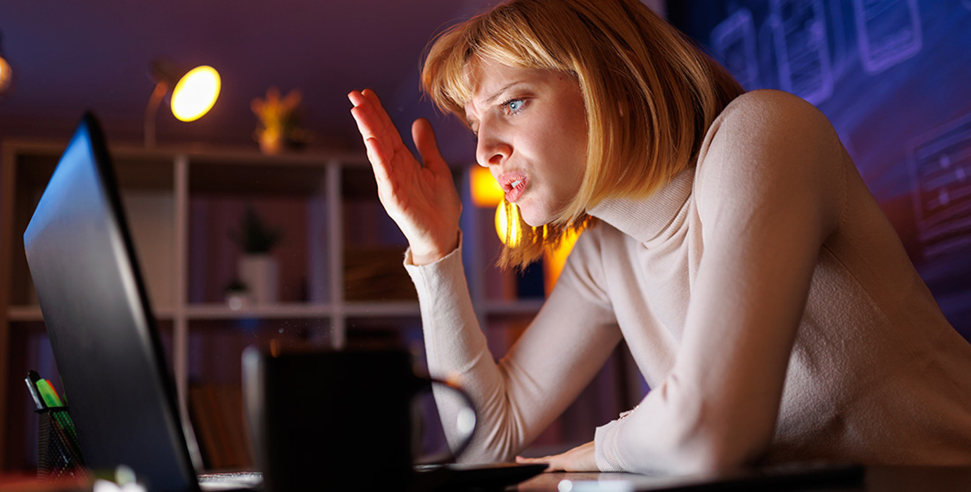 Someone anxious working on laptop at night