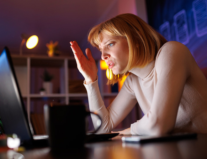 Someone anxious working on laptop at night