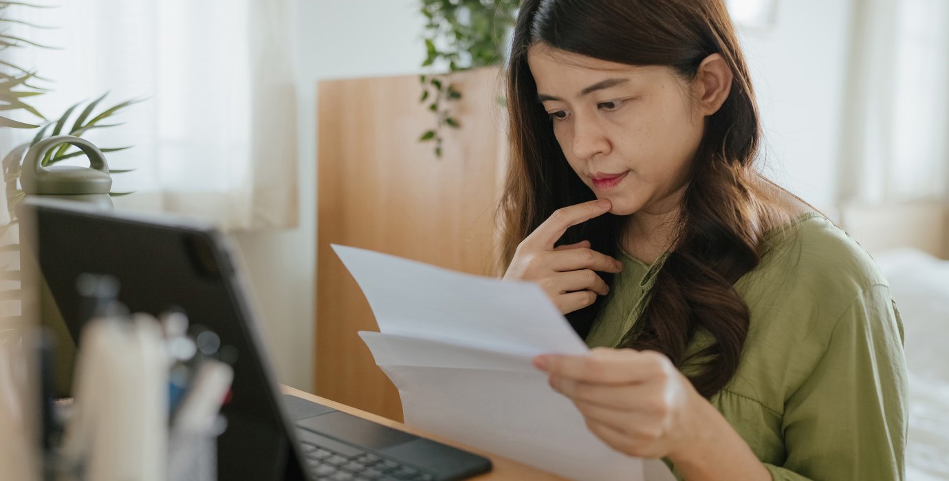 Person looking at papers and trying to make a decision.