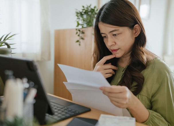 Person looking at papers and trying to make a decision. 