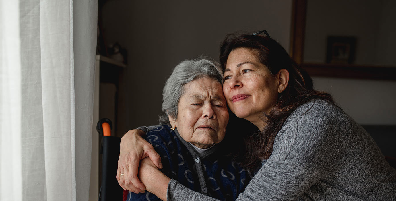 2 people hugging while at home