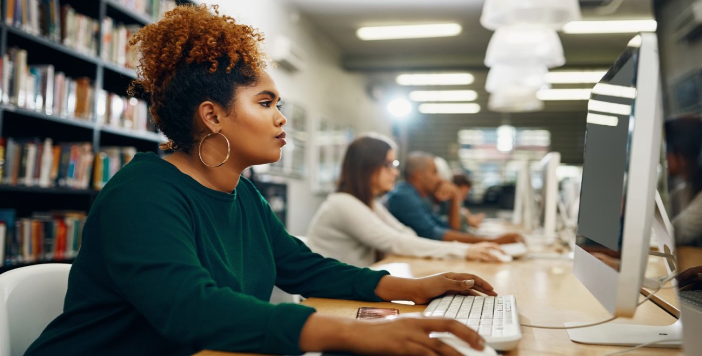 Job seeker using a desktop computer in a library.