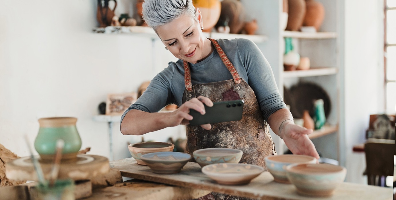 Woman taking picture of pottery