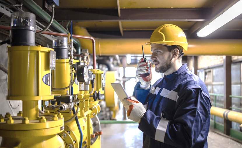 oil pipeline operator or maintenance worker checking pipes