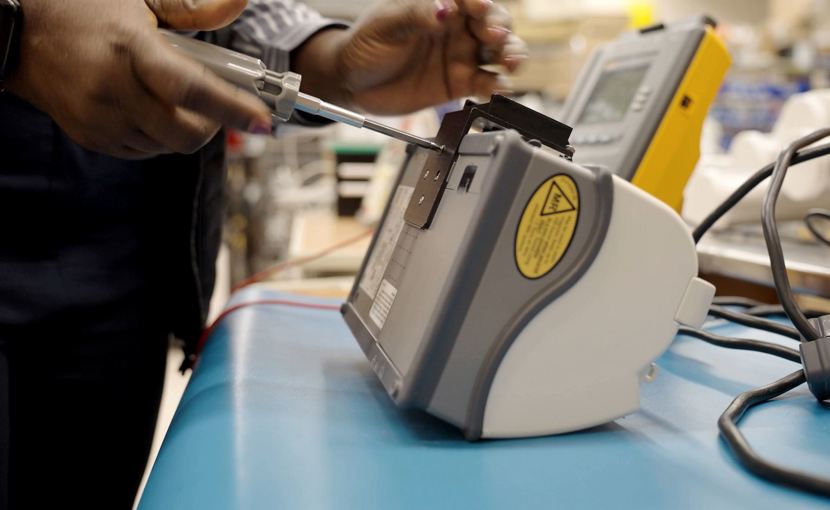 biomedical engineering technologist working on equipment