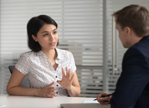 Female worker talking to her manager in office. 