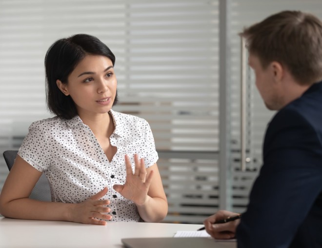 Female worker talking to her manager in office. 