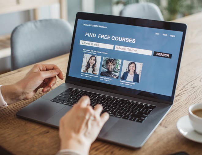 Person searching for free online courses on laptop. 